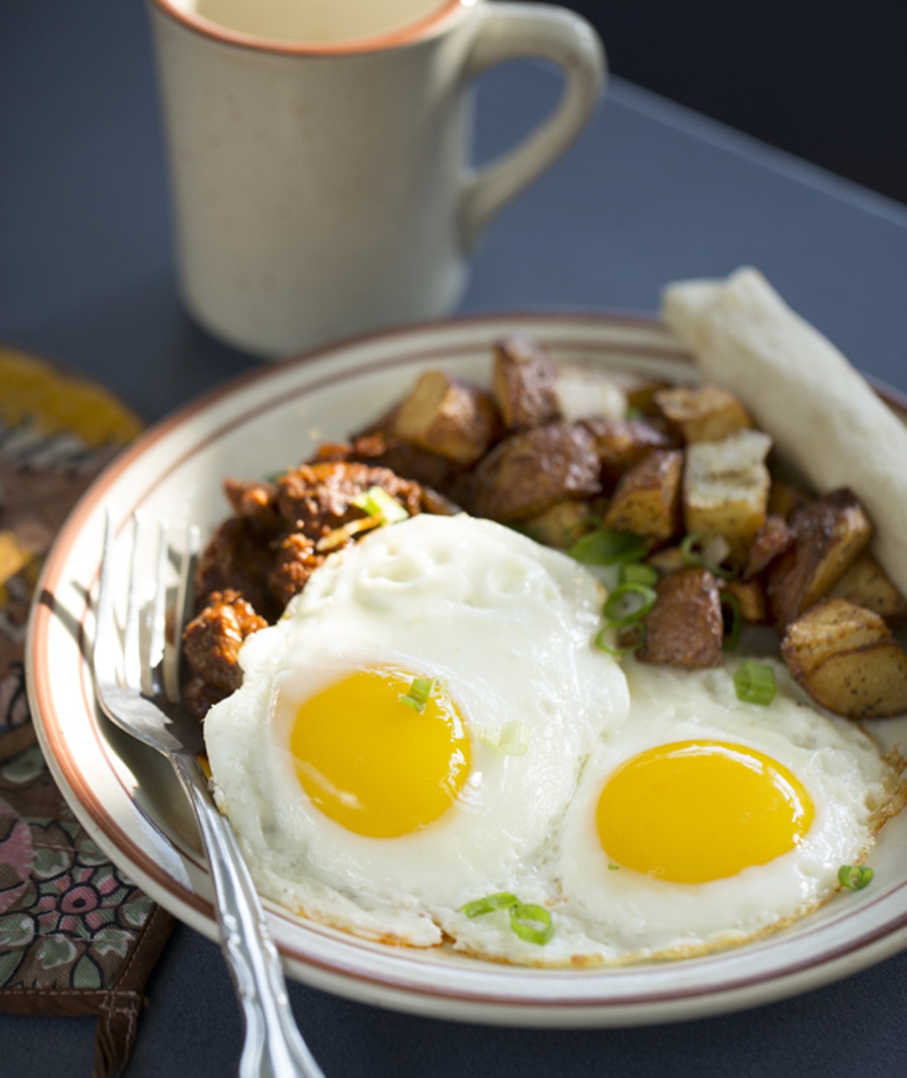 Carne Adovada - red chile marinated & braised pork served with two eggs any style (sunny side up shown here), home fries and tortillas.