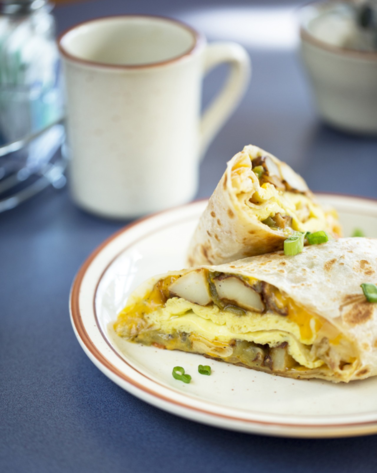 New Mexican Breakfast Burrito - a flour tortilla with scrambled eggs, cheese, green chile and home fries. Add bacon, turkey bacon, sausage, ham, chorizo or calabacitas.