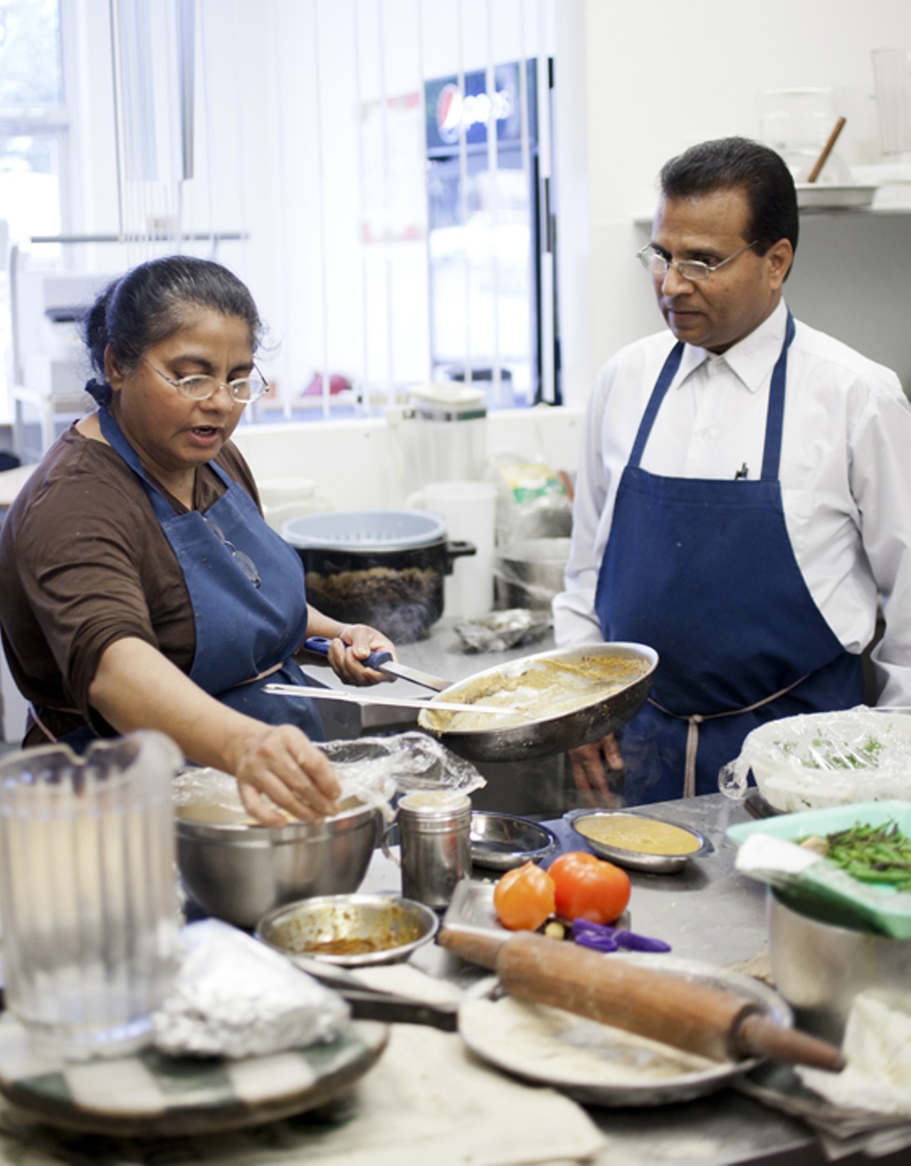 Shaheena and Zahid Khan at work in the Spice-n-Grill kitchen.
