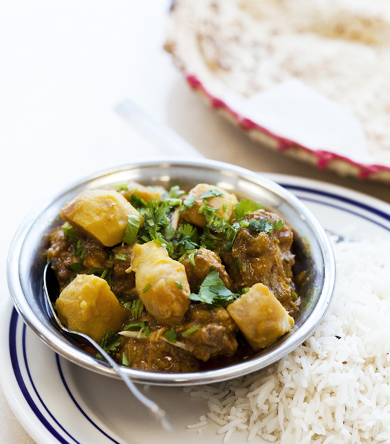 Chicken Vindaloo is cooked with potatoes, tomatoes and spices.