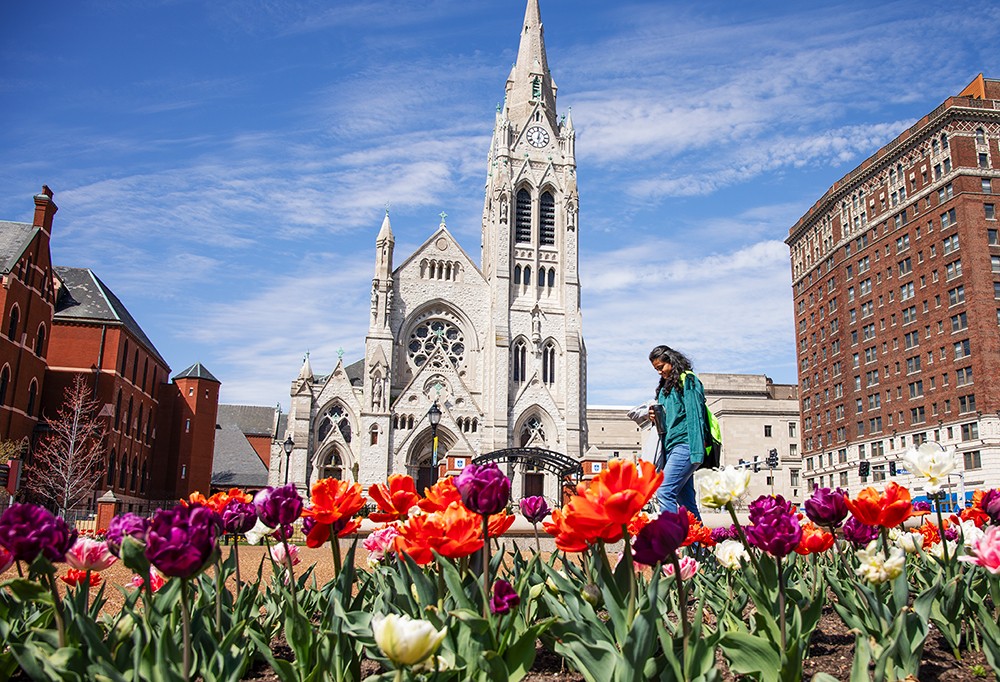 Sravani Pendyala walks past blooming tulips on Saint Louis University’s campus on Wednesday, March 20, 2024.