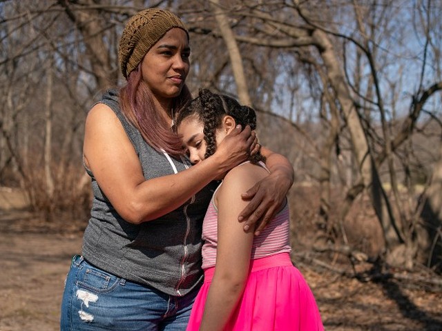 Alexandra Sierra and one of her daughters hug outside their home in Bergen County, New Jersey, on March 9.