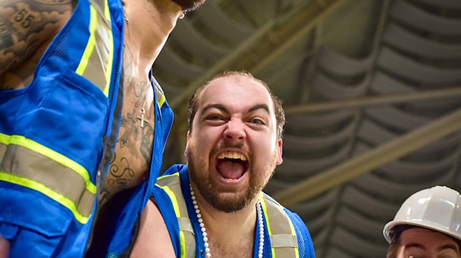 A man screams into the camera with his mouth wide open.