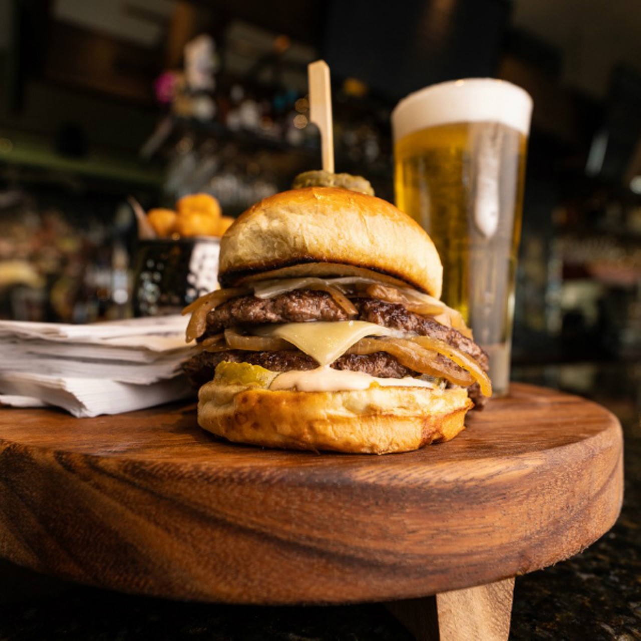 Bar Louie
(14 Maryland Plaza; 314-678-3385)
6 Napkins Burger:  Two smashed slider patties, grilled with yellow mustard, topped with caramelized onions, double white cheddar, pickles and Louie sauce.