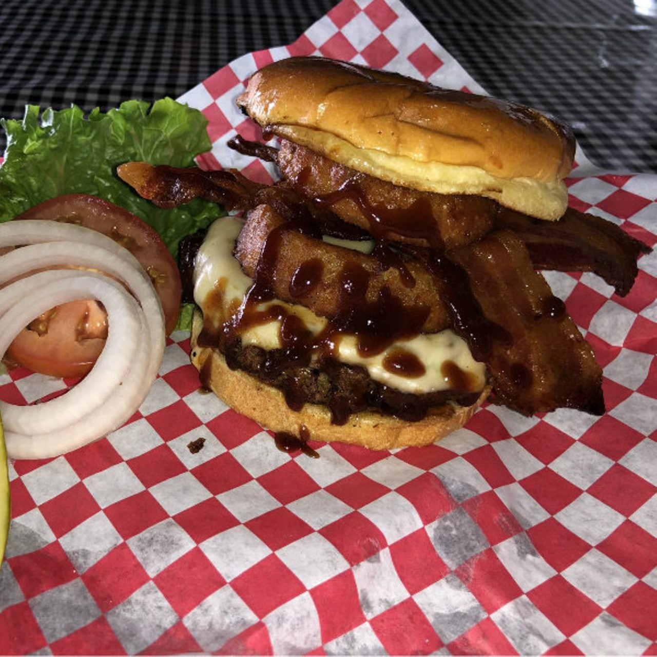 Sharpshooter Pit & Grill
(8135 Gravois Road; 314-353-4745)
The Cowboy - Our half pound burger topped with our signature BBQ sauce, pepper cheese, onion rings, and cherry smoked bacon on a soft, butter toasted bun.