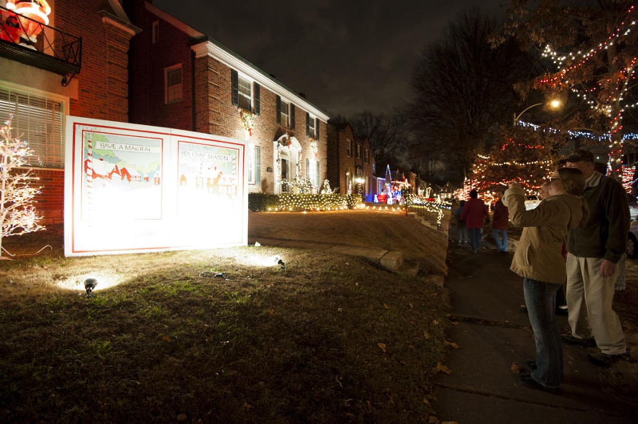 People photographing Christmas displays on the 6500 block of Murdoch Avenue in South City.