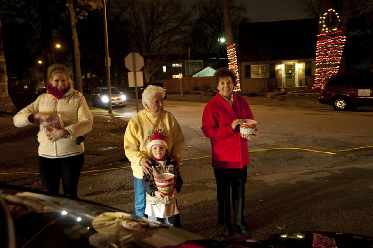 Mary Elliott, Mitch Hanneken, Erna Sinovcic and Tyler Kern, 5, collect donations for Camp Happy Day from passing cars and distribute candy canes on Wednesday night on the 6500 block of Murdoch Avenue. Hanneken founded Camp Happy Day in 1971 to help children with learning disabilities, speech/language impairments, behavior disorders and signs of Autism.