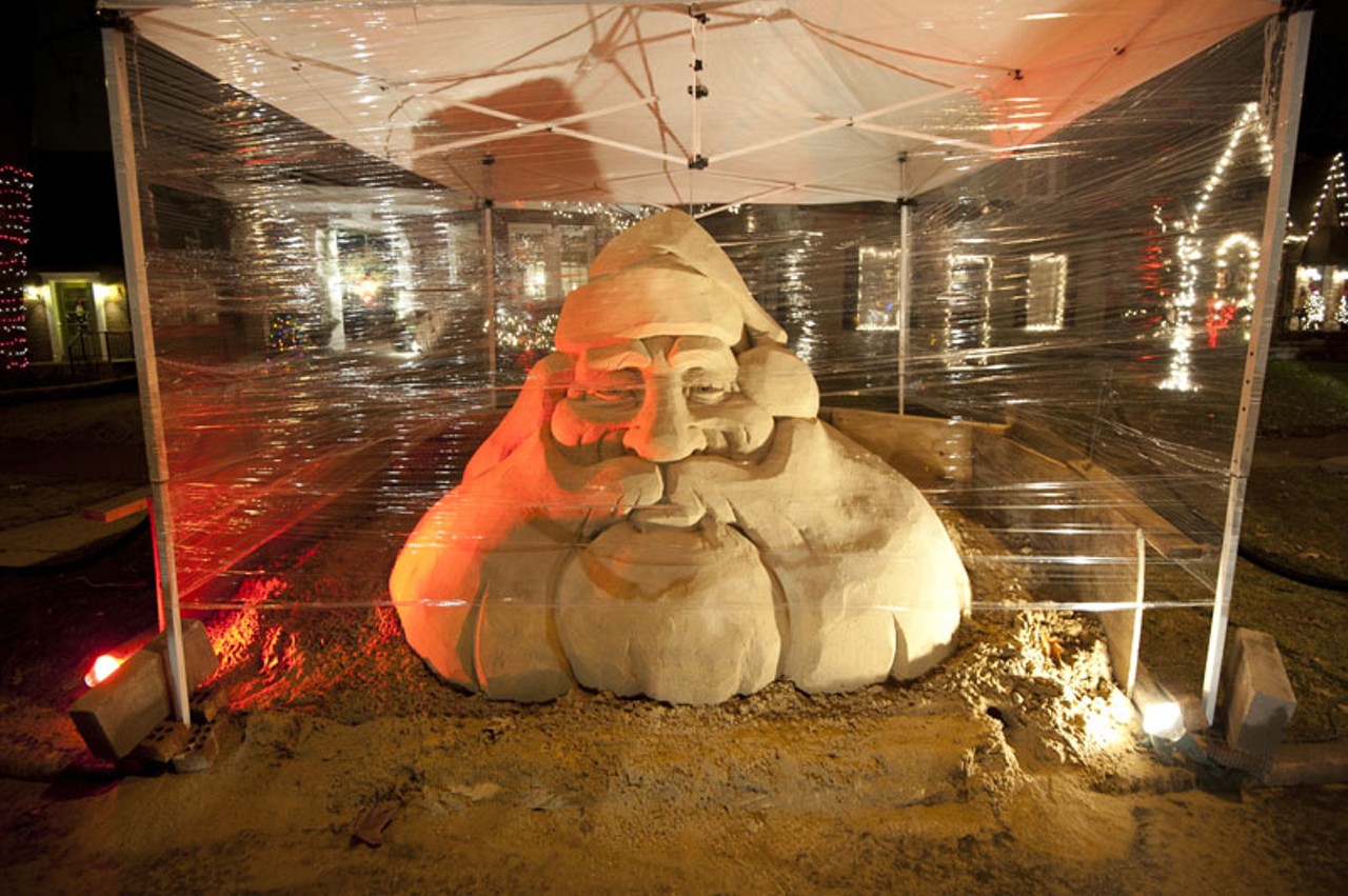 A roped off Santa display, made with 7 tons of sand, sits on the 6500 block of Murdoch Avenue during the holiday season.