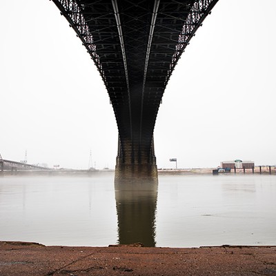 A light layer of fog hovers above the Mississippi River underneath the Eads Bridge.