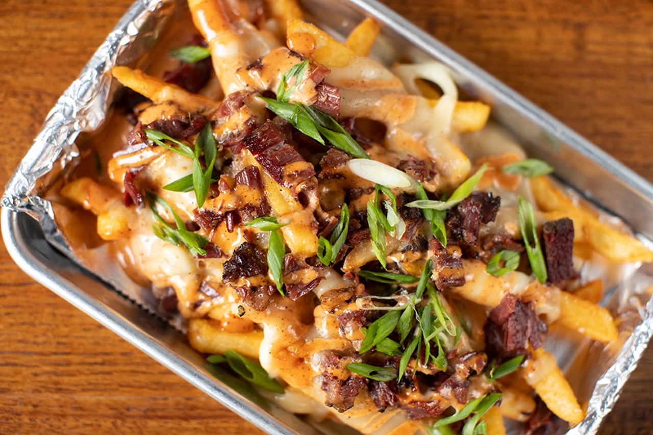 Pastrami poutine made up of gravy-smothered fries, provel cheese, pastrami and scallion.