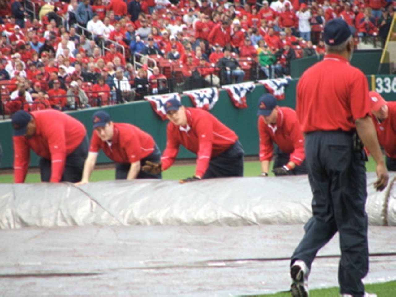 Practicing for the rain. The grounds crew rolled out the tarp for real a few innings later.