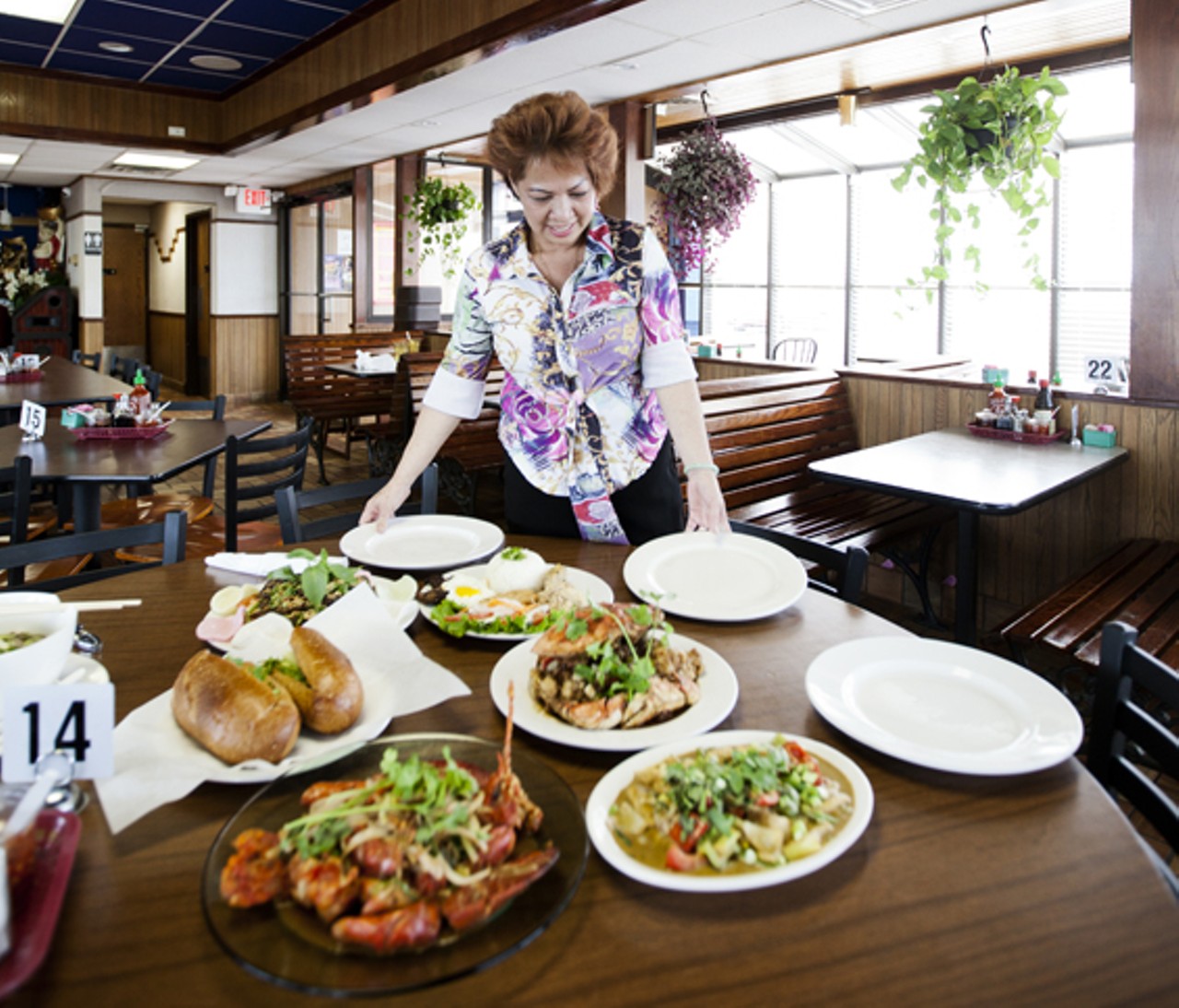Owner Lyn Chieng setting a table.