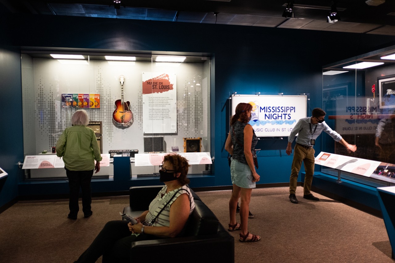 Andrew Wanko tells museum guests about the Mississippi Nights display. Next to the display, there's a trivia game and a section on mixing boards created in St. Louis.
