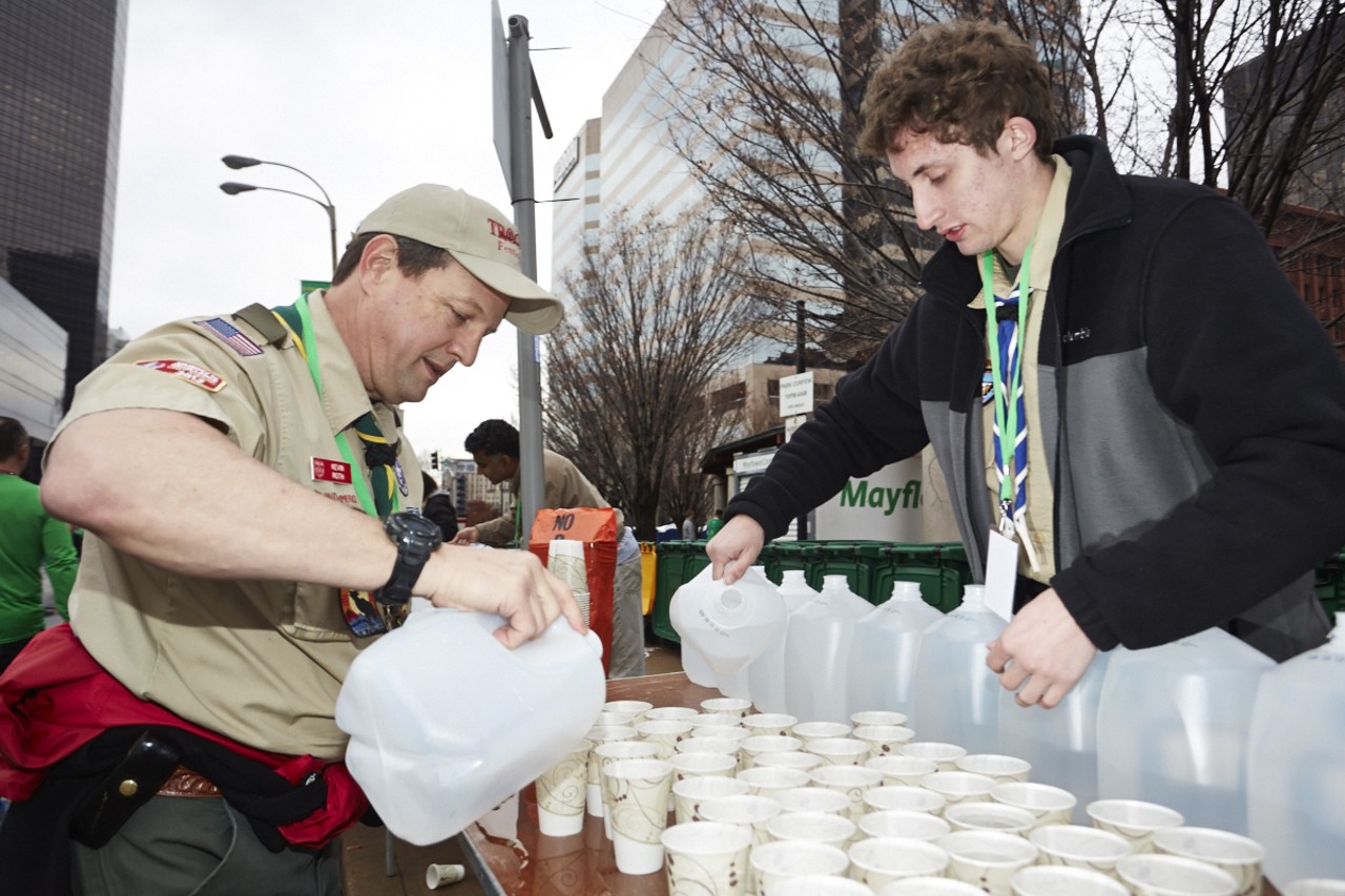 Kevin Roth and Nick Kremer from Troop 778 in Fenton help pour water for the runners at the 37th Annual St. Patrick's Day Parade Run in downtown St. Louis on March 14, 2015.