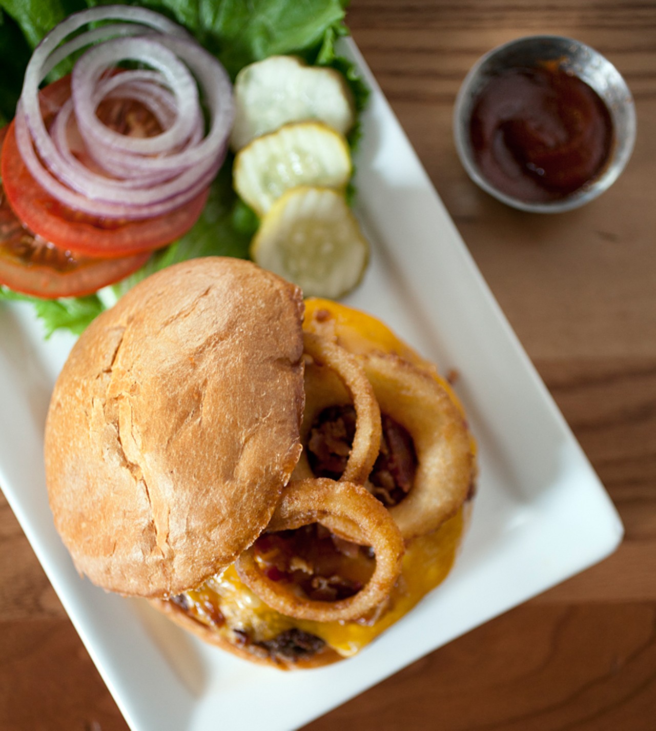 The "Gateway Burger" is served with smoked bacon, crispy onion rings, cheddar cheese and barbecue sauce.