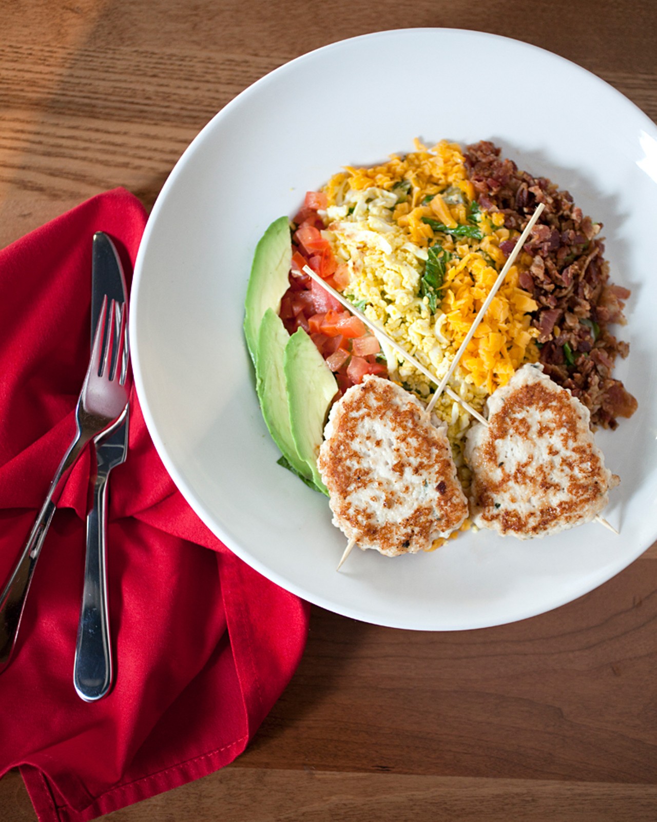 The "Turkey Burger" cobb salad is served with grilled natural turkey, organic romaine lettuce, smoked bacon, avocado, tomatoes, cheddar and egg, with a black peppercorn ranch dressing.