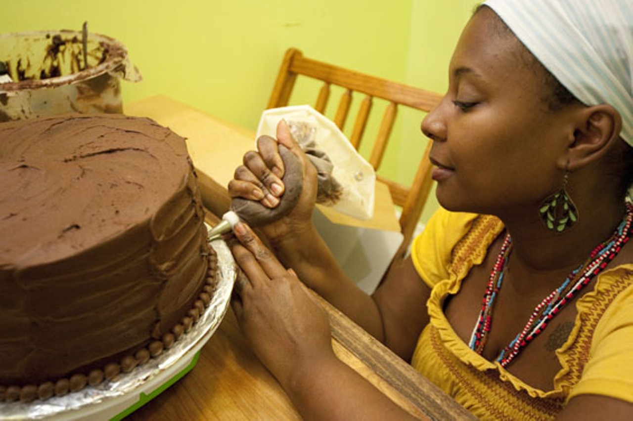 Owner Reine Bayoc adding the finishing touches to a cake.