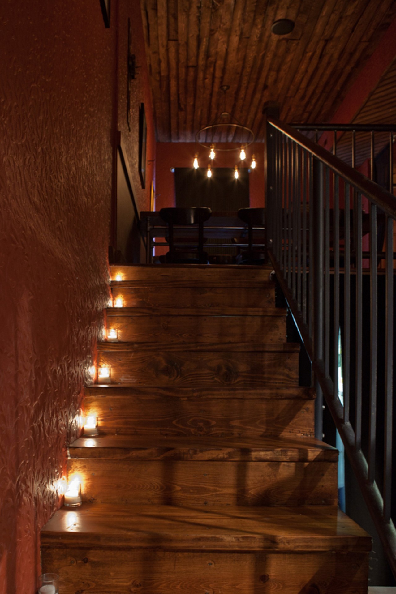 Candlelit stairs leading to the upstairs of Taste.