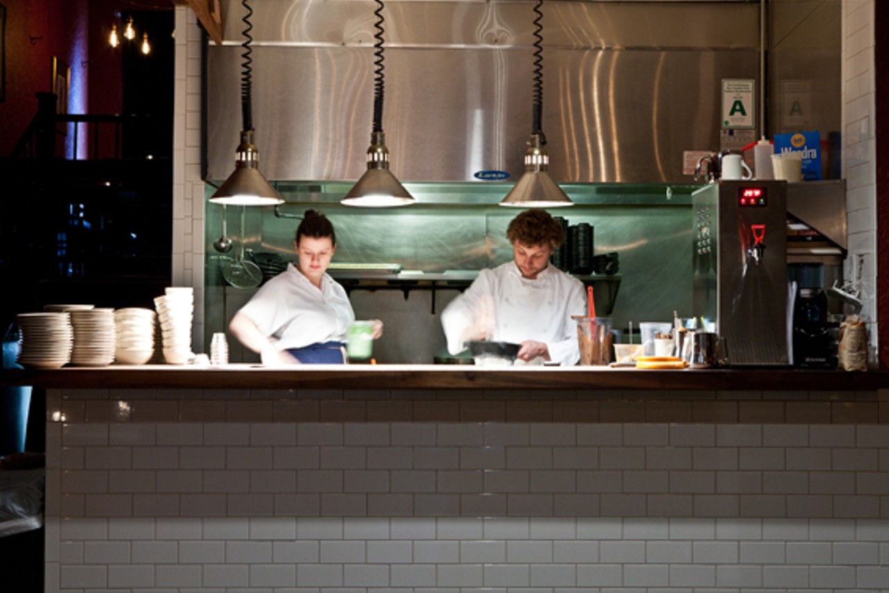 Merritt Duncan, and manager, Adam Altnether, preparing food in the kitchen.