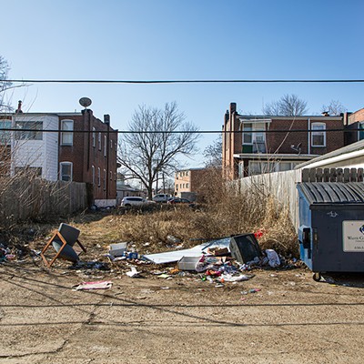 Overflowing dumpsters and garbage lines the alley behind 4236 Neosho Street on Tuesday, February 6, 2024.