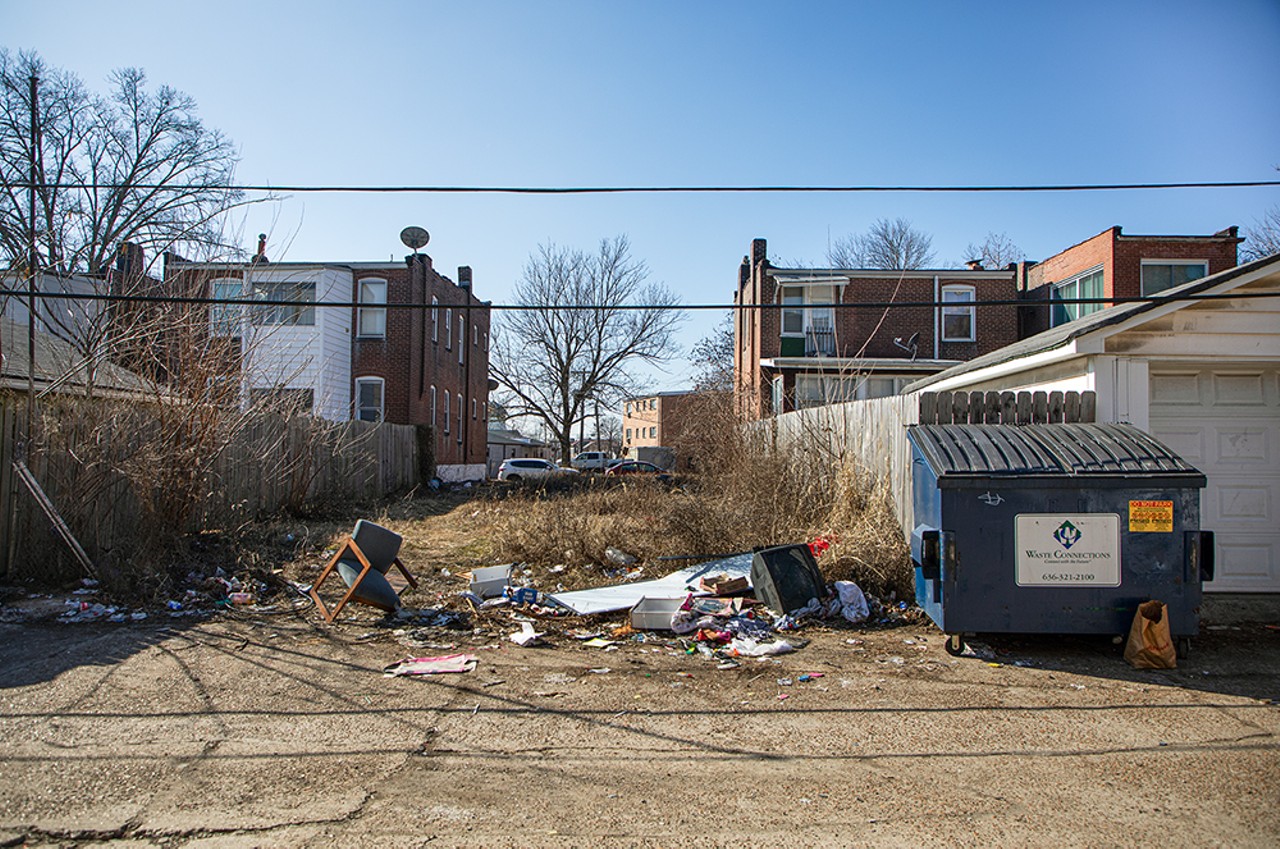 Overflowing dumpsters and garbage lines the alley behind 4236 Neosho Street on Tuesday, February 6, 2024.