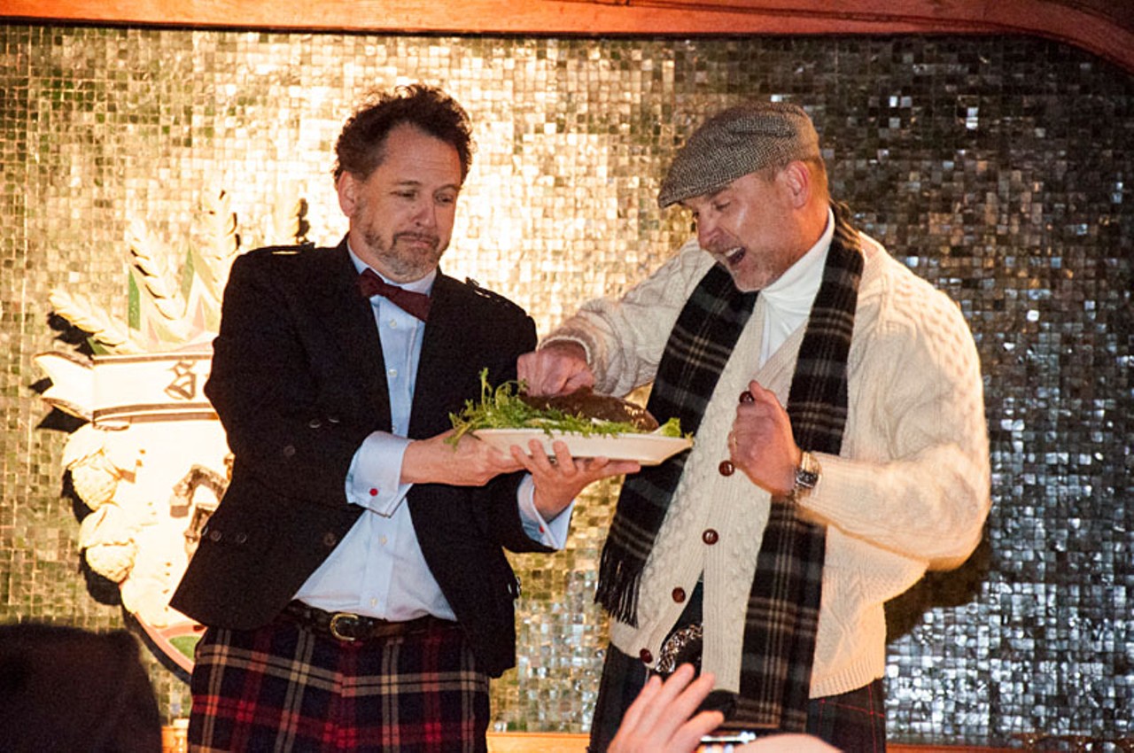 During the ritual to summon the ghost of Robert Burns' back from the dead, Dan Kopman holds the haggis and John Meyer  stabs the haggis in the middle of his story.