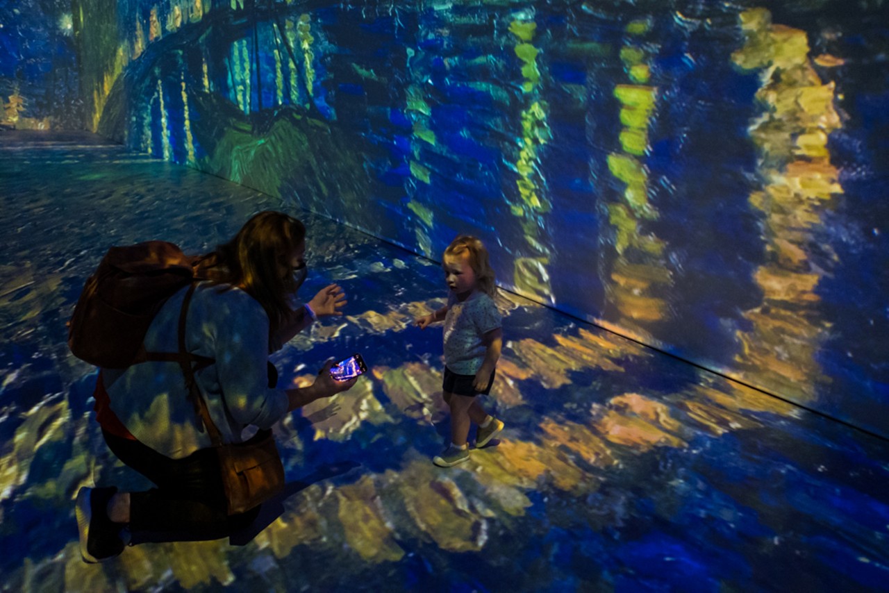 After the waterfall room, you step into the main exhibit where the paintings are projected. Here, a little girl steps into Starry Night Over the Rh&ocirc;ne.