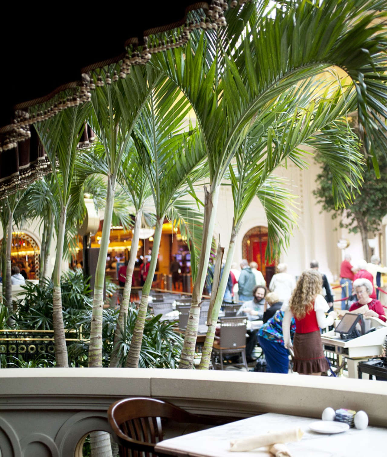 The indoor "patio" at 1904 Beerhouse is lined with palm trees.
