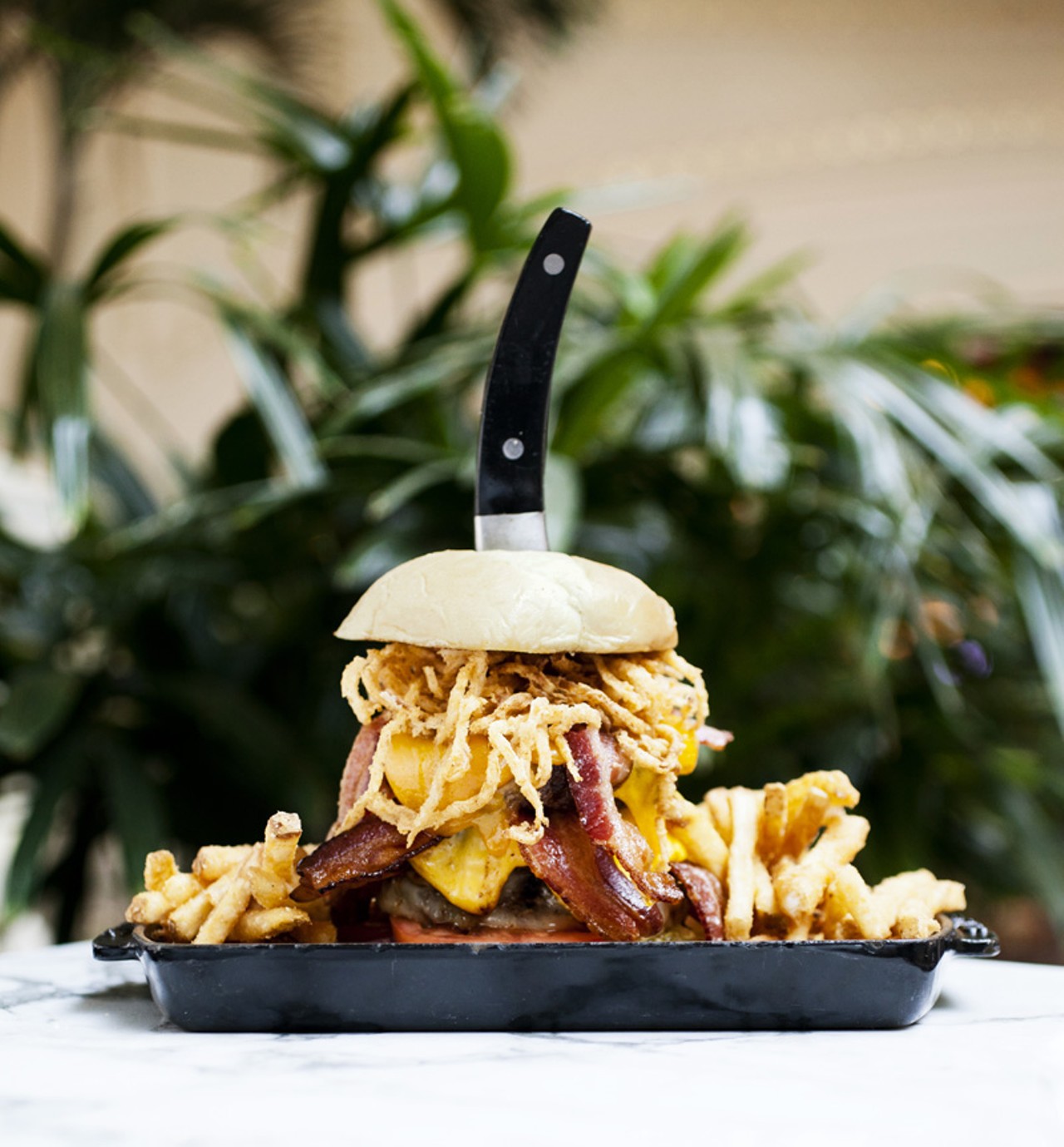 The Triple Bypass is three, yes count 'em, three 8 ounce Angus burgers with six strips of applewood smoked bacon, tomatoes, fried onion straws, mayonnaise, house-made steak sauce and your choice of three cheeses.