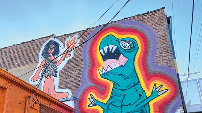 Mural of a dinosaur and a girl.