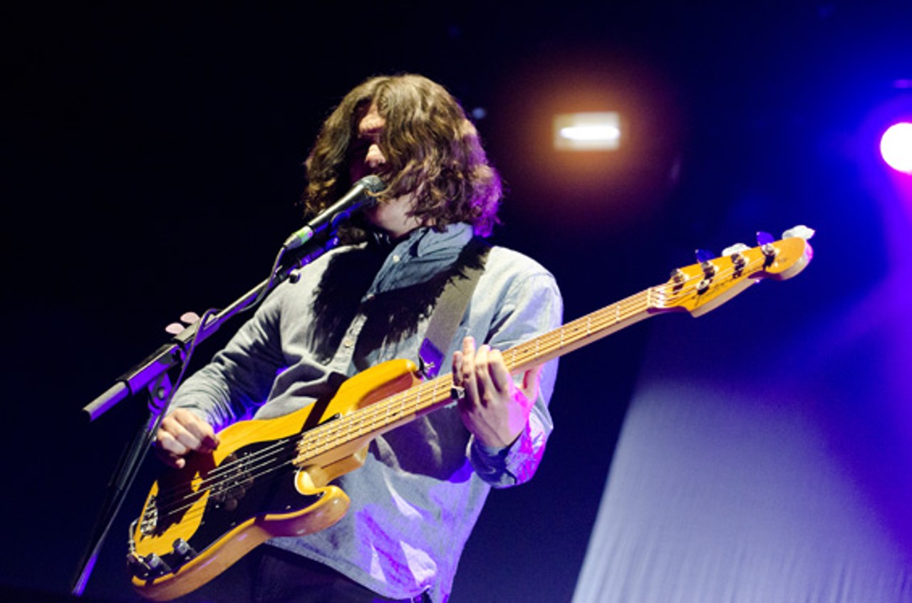 Nick O'Malley of Arctic Monkeys performing at the Chaifetz Arena in St. Louis on Friday, April 27.