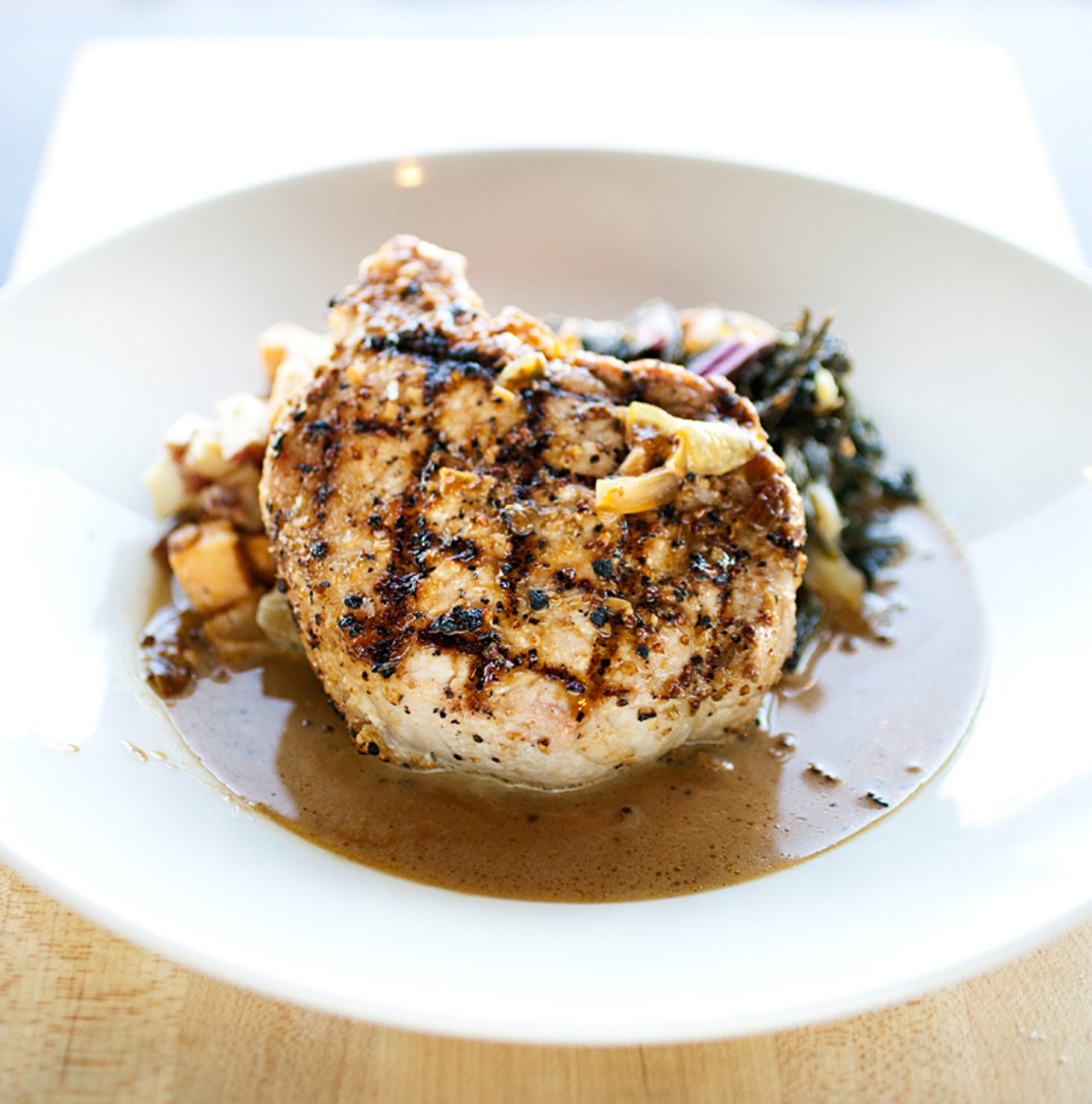 Here's Rensing's Farm pork chop with sweet-potato-and-bacon hash, braised greens and a grain-mustard pork sauce.