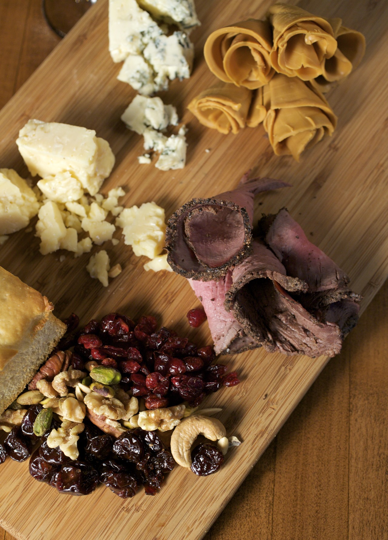 One page of the menu is a four-column chart where you select, a la carte, a cheese and charcuterie plate. Shown here is a richly nutty and sweet Norwegian cheese (on top right), Gjetost. Then, going clockwise, is a dry rubbed smoked NY strip, dried fruits and nuts that accompany every a la carte cheese and charcuterie plate along with the bread. Then there is the Jasper Hill Cellar Aged, which is a Vermont, buttery cheese with a clean, tangy finish. And last, a Rogue Creamery Smoky Blue from Oregon. It has a hint of smoke, which gives way to sweet and salty.