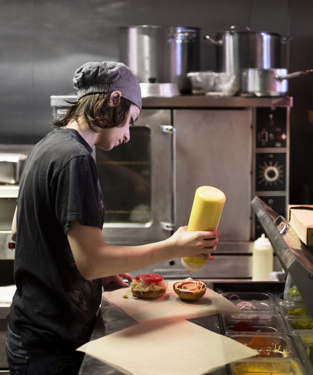 Brittney Froelich, sous chef, prepares a burger.