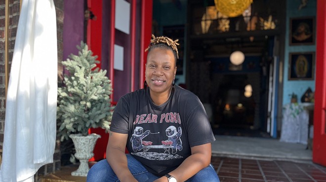 Co-owner LaTosha Baker sits on the golden steps of the Drip Community Coffee House.