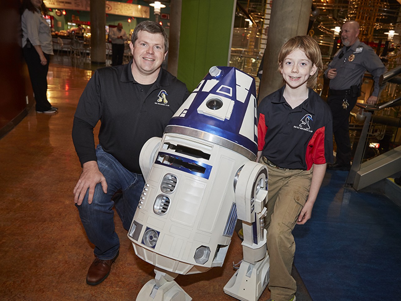 Craig and Justin Crawford, members of the R2 Builders Club of St. Louis, with the droid of the hour.