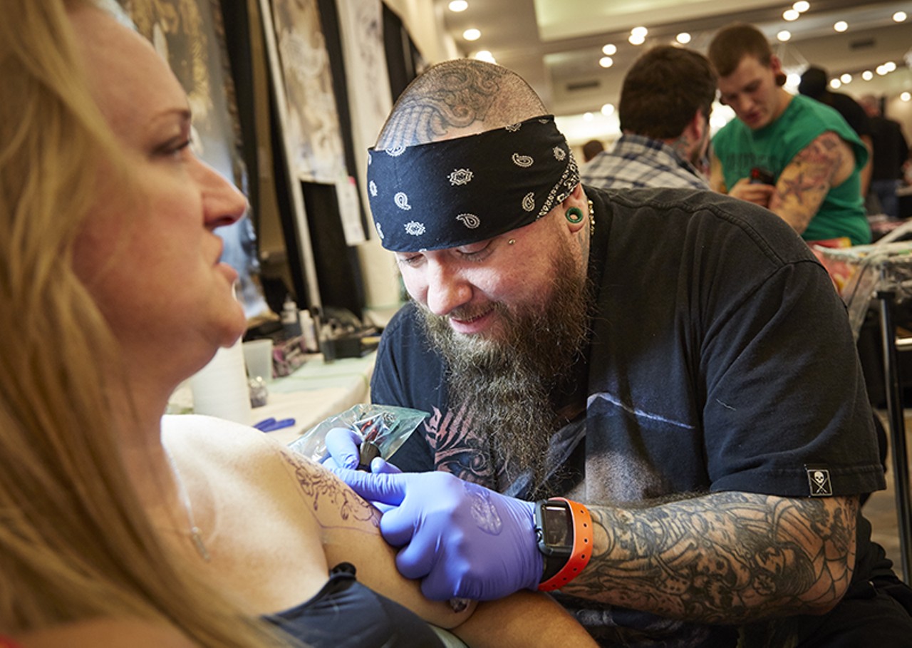 George Zabala from Tattoo City inking an arm.