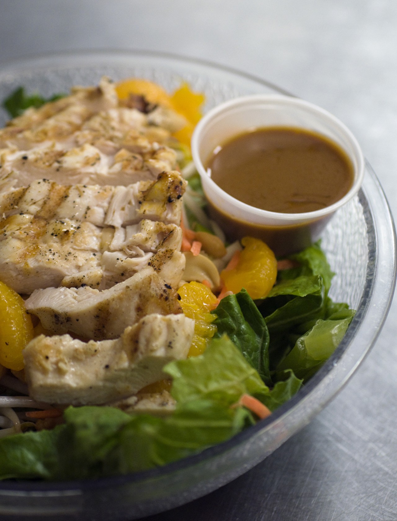 That same grilled chicken, now atop the Thai Chicken Salad, which is comprised of grilled marinated chicken atop crisp romaine, bean sprouts, cashews, mandarin oranges, green onion, carrot and a side of Thai peanut sauce.