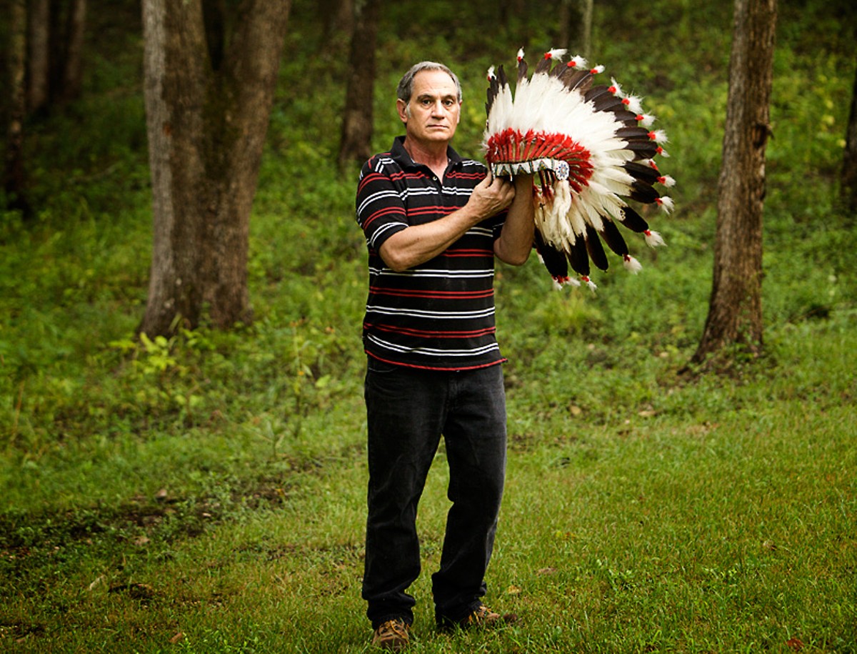 Kevin Airis shows off one of the two eagle-feather headdresses the Science Center returned to him in 2007.