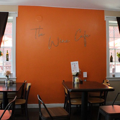 A bright orange wall pops inside the cafe.
