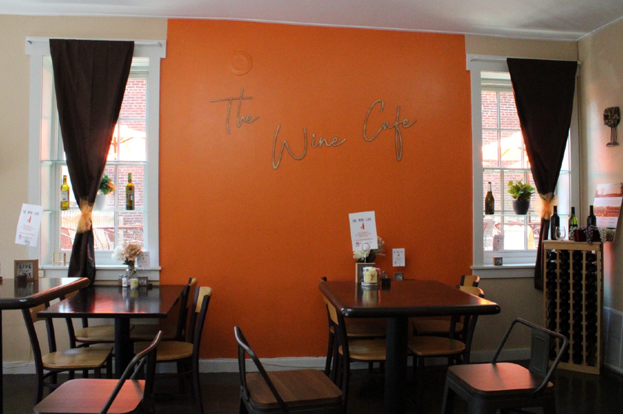 A bright orange wall pops inside the cafe.
