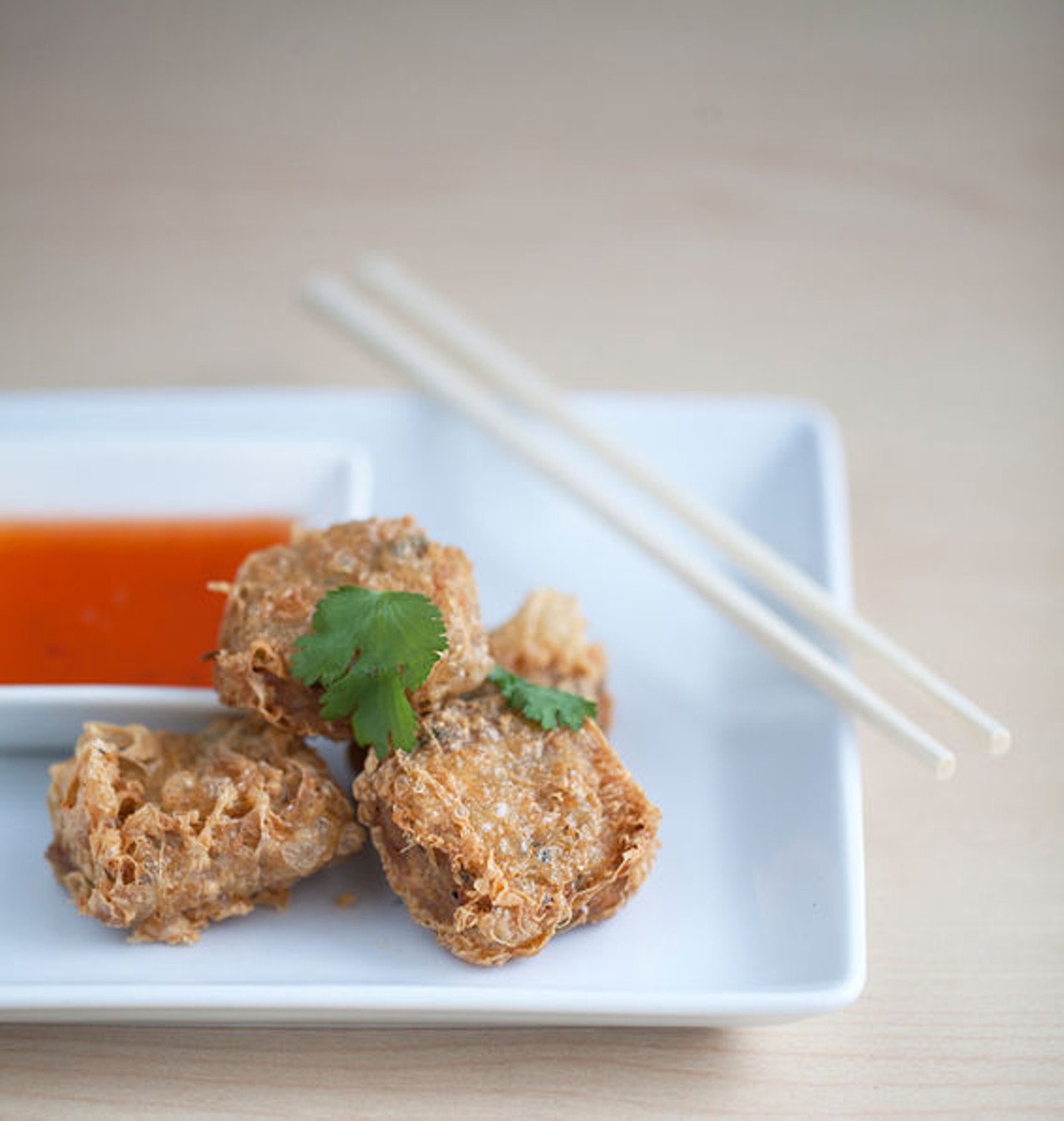 From the appetizer menu, Hoy Jaw. Deep-fried dumplings with crab and shrimp mixed with minced pork, wrapped in tofu skin, and served with a Thai sweet chili sauce. See more photos: Inside Fork & Stix in the Delmar Loop area.