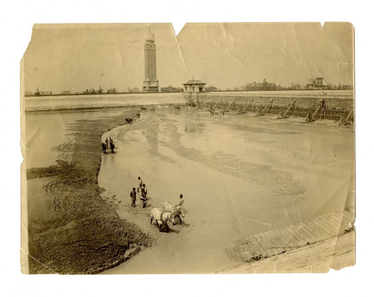CLEANING MUD FROM THE COMPTON HILL RESERVOIR, EARLY 1900s
"The 1871 St. Louis water system provided citizens with reliable water, but it still wasn't clean. Periodically the city reservoirs had to be drained and feet of mud scraped from their bottoms." &#151; Andrew Wanko, 'Great River City'
Missouri Historical Society Collections