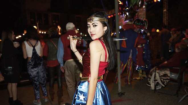 A woman poses in a costume during the CWE Halloween party.