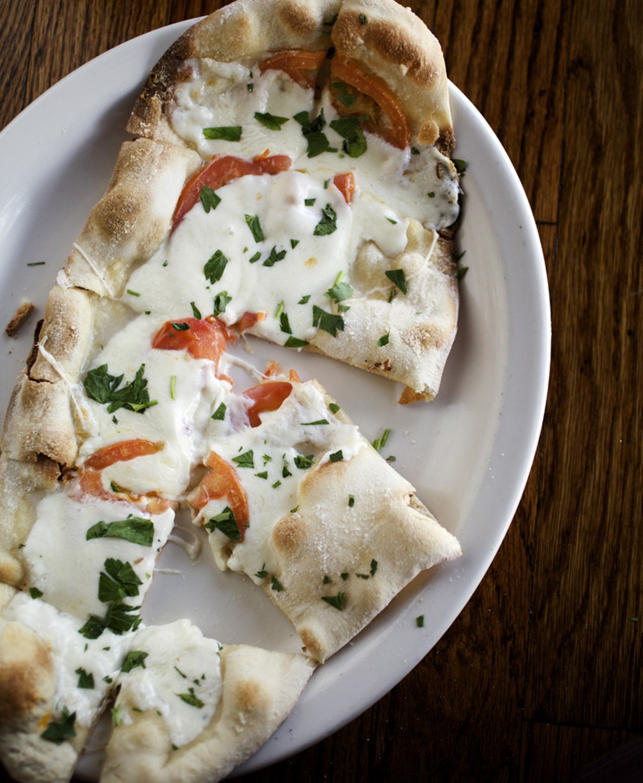 Caprese flatbread - stone baked flatbread topped with fresh tomatoes, mozzarella and basil, also available on both the regular and late night menus.