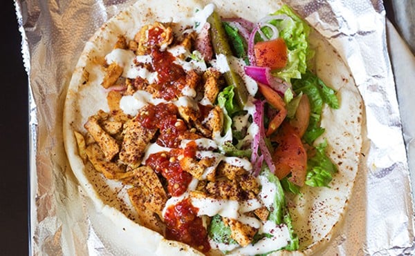 Medina Mediterranean Grill's "Original Palestine," or chicken shawarma with lettuce, tomato, onion, pickle, tahini and added chile sauce.