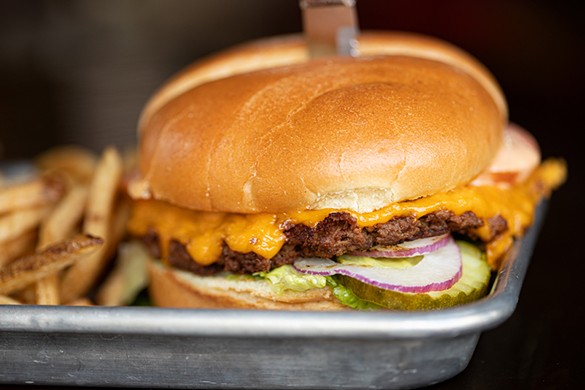 The Signature Station Burger is a housemade quarter-pounder with cheddar, pickles, jalapeño, lettuce, tomato, onion and pub sauce.
