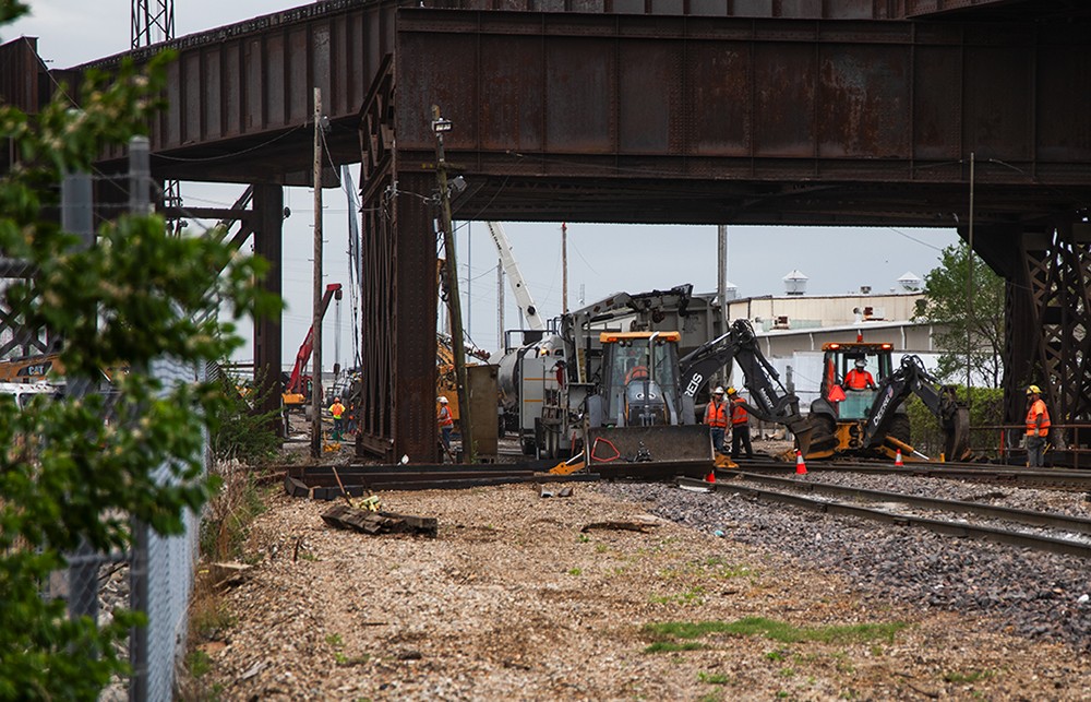 Crews work to flip derailed railcars upright on Tuesday, April 16, 2024, in St. Louis.