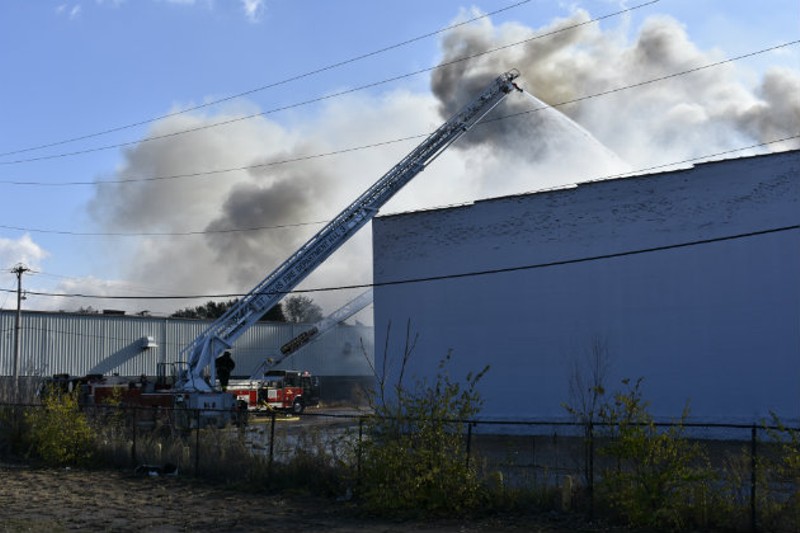 Firefighters pour water on warehouse fire in Botanical Heights. - PHOTO BY DOYLE MURPHY