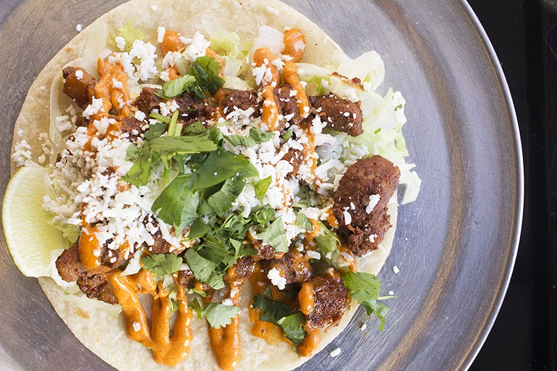 The al pastor taco is topped with red chile cream, cotija cheese and cilantro. - MABEL SUEN